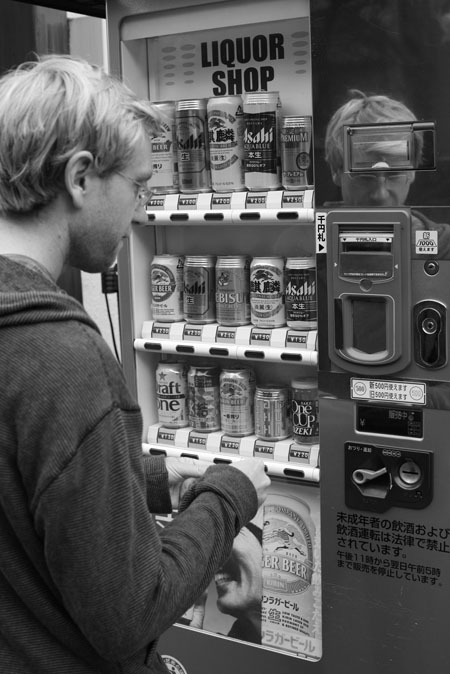 Aaron buys beer from a vending machine